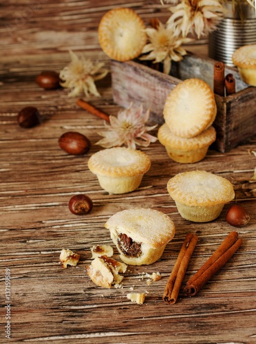small round Christmas cakes with nuts and cinnamon, space for text