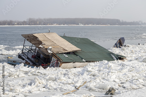 Crashed raft house and fishing boat photo