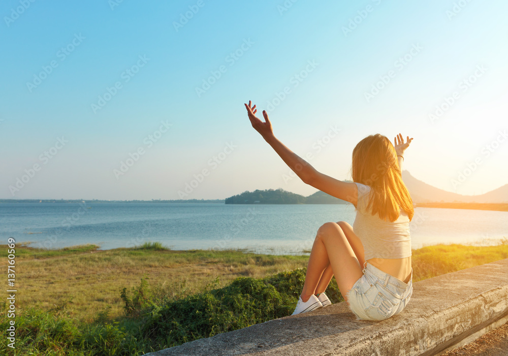 Girl relaxing and enjoying peace and serenity on beautiful nature.