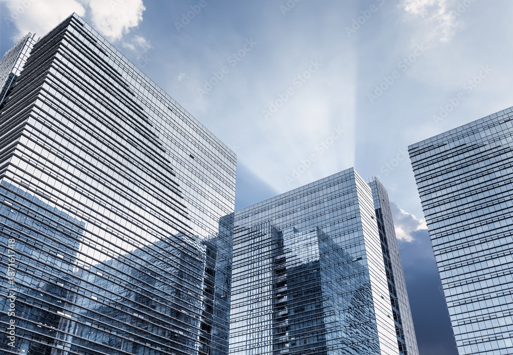 glass building with dramatic sky