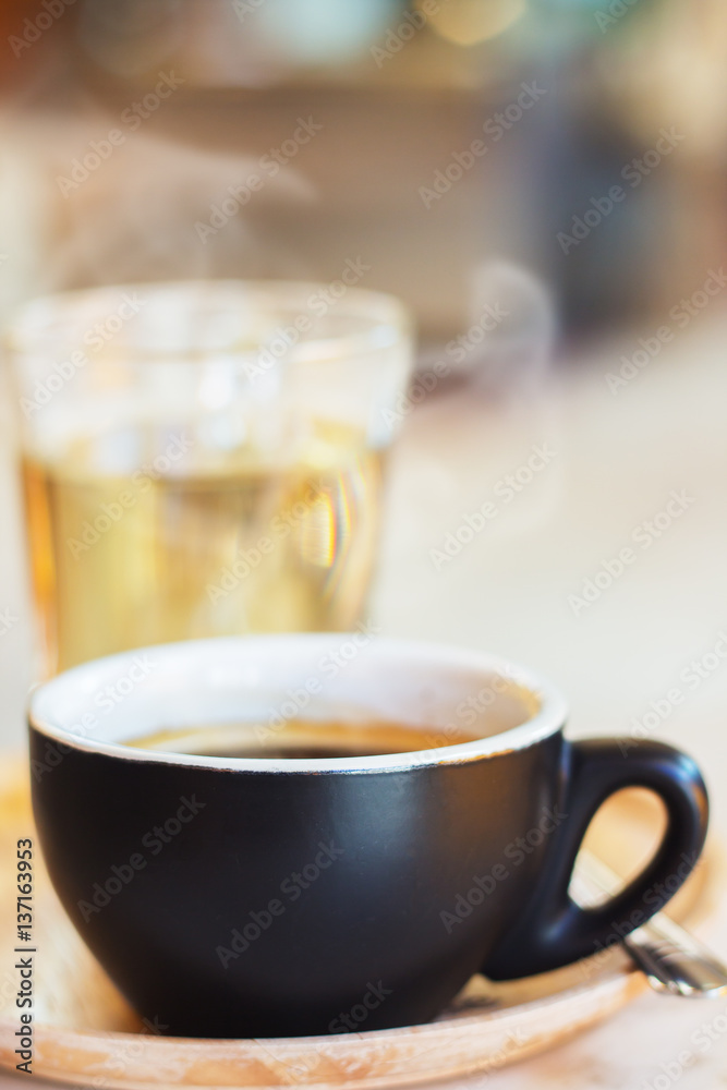 Close up coffee cup with steam on table in cafe. Close up coffee cup with steam on table in cafe.