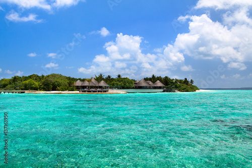 Lagoon and beach bungalows on Maldives Island © smilingsunray