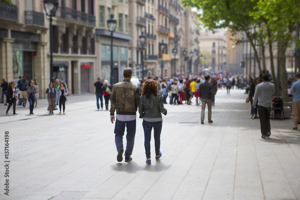 Couple walking down the streets of Barcelona, Spain. Light tilt shift effect. Couple walking down the streets of Barcelona, Spain. Light tilt shift effect.