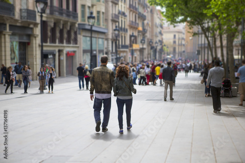 Couple walking down the streets of Barcelona, Spain. Light tilt shift effect.