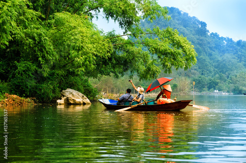 Traveling by boat on streams YEN in Hanoi, Vietnam. photo