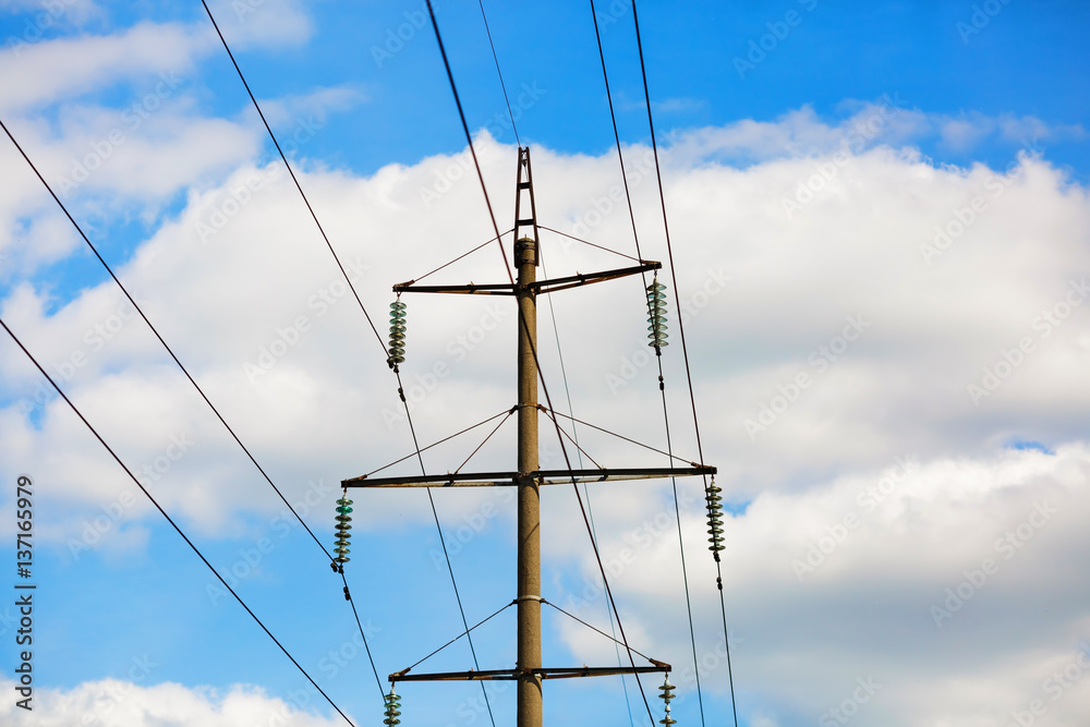 Old power lines. Electricity transmission pylon against the blue sky. High voltage tower. Old power lines. Electricity transmission pylon against the blue sky. High voltage tower.