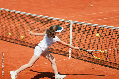 Tennis junior on the net © Microgen