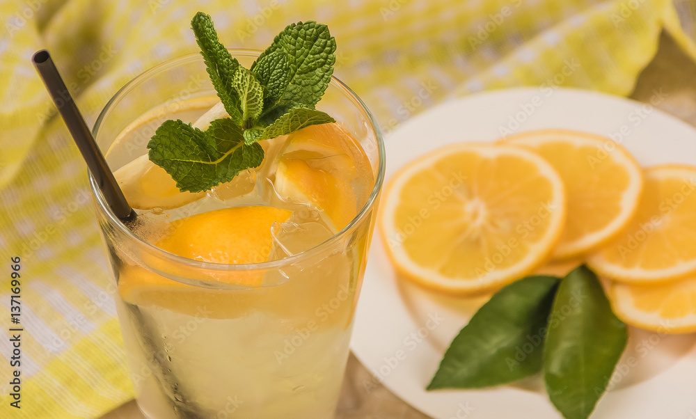 Fototapeta premium Fresh lemonade in glass with mint and ice