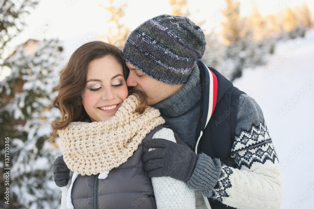 happy loving couple walking in snowy winter forest, spending christmas vacation together. happy loving couple walking in snowy winter forest, spending christmas vacation together.