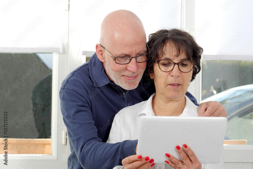 Portrait of a happy senior couple using tablet digital Portrait of a happy senior couple using tablet digital