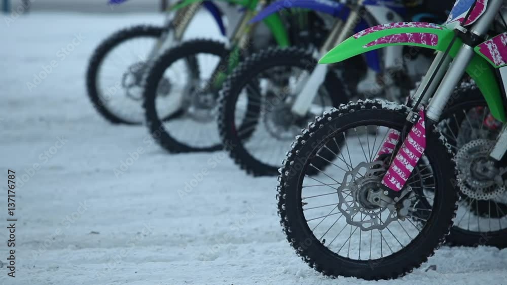 Motorcycles at the starting line close to winter motocross  with sound