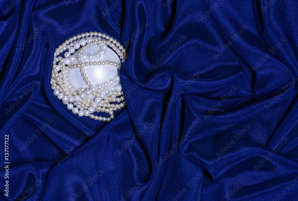 Pearl necklace on draped fabric Pearl necklace on draped fabric