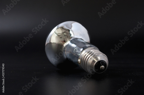 economical light bulb on a black background.