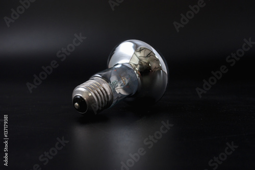 economical light bulb on a black background.