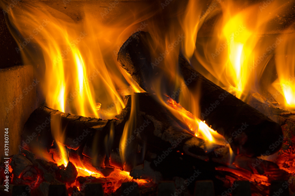 The fire in the fireplace burning wood The fire in the fireplace burning wood