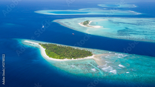 Small tropical island in Maldives atoll photo