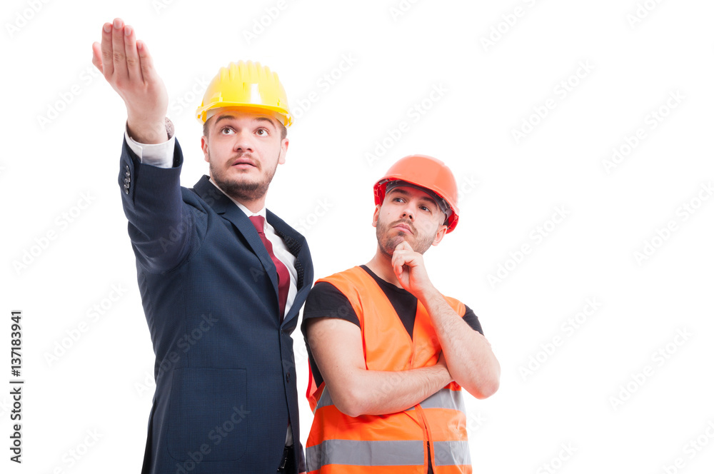 Bussinesman explaining something to young builder Bussinesman explaining something to young builder