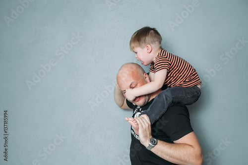 stressed young dad with two small child in his arms