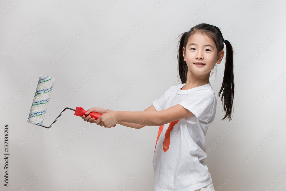 Cute asian girl holding paint roller Cute asian girl holding paint roller