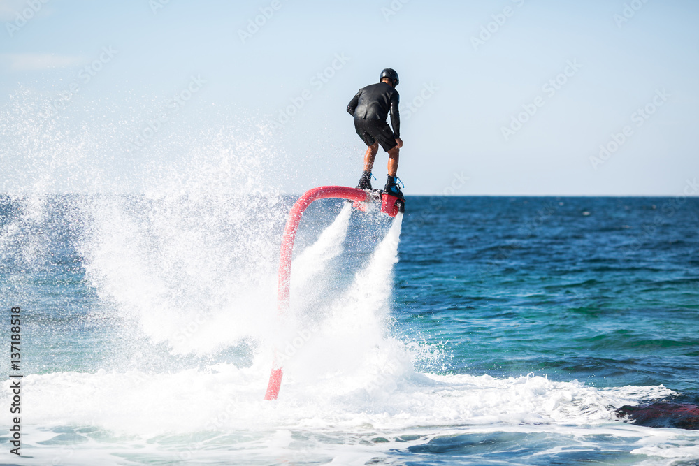 Silhouette of a fly board rider at sea