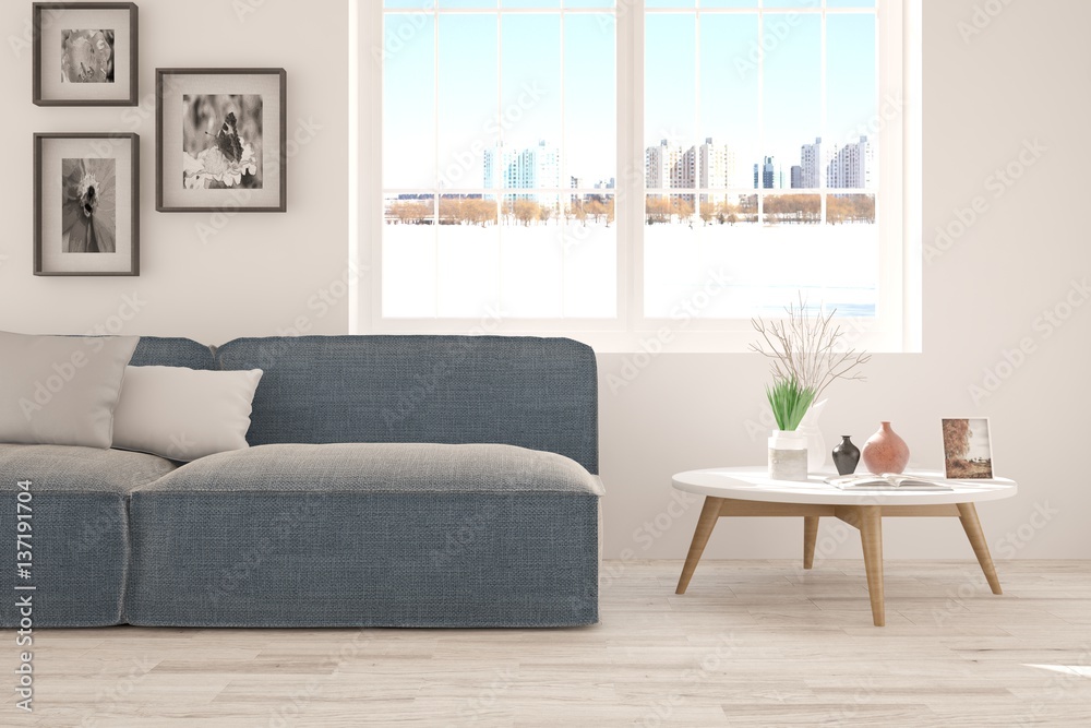White room with sofa and urban landscape in window. Scandinavian interior design White room with sofa and urban landscape in window. Scandinavian interior design