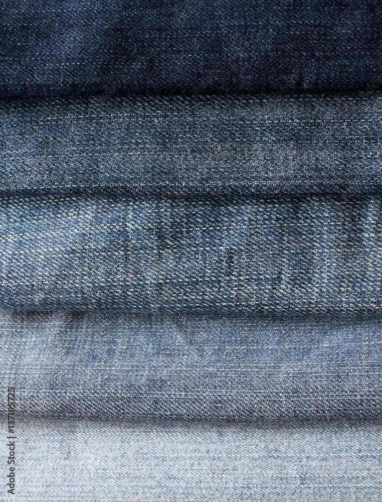 background from strips of blue jeans of different shades and brightness