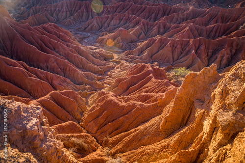 Red hills of Tatacoa Desert bathed in sunlight in Huila, Colombia photo