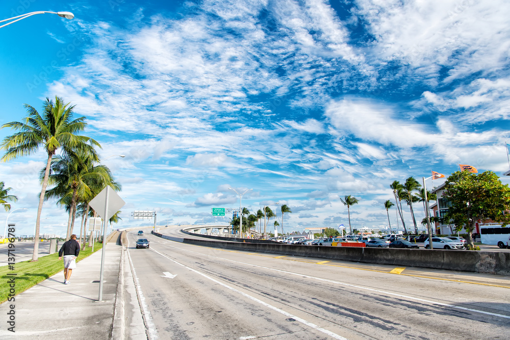 Fototapeta premium highway with skyscrapers on blue cloudy sky