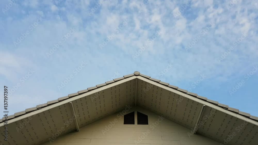 time lapse clouds in the sky with foreground of house roof time lapse clouds in the sky with foreground of house roof