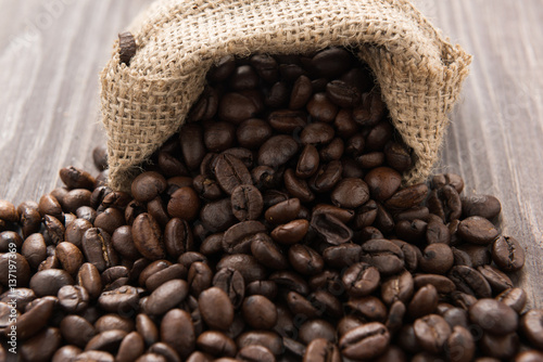 coffee beans in a bag on wooden background