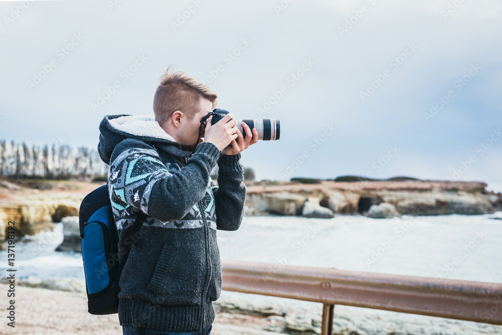 Young photographer on the beach