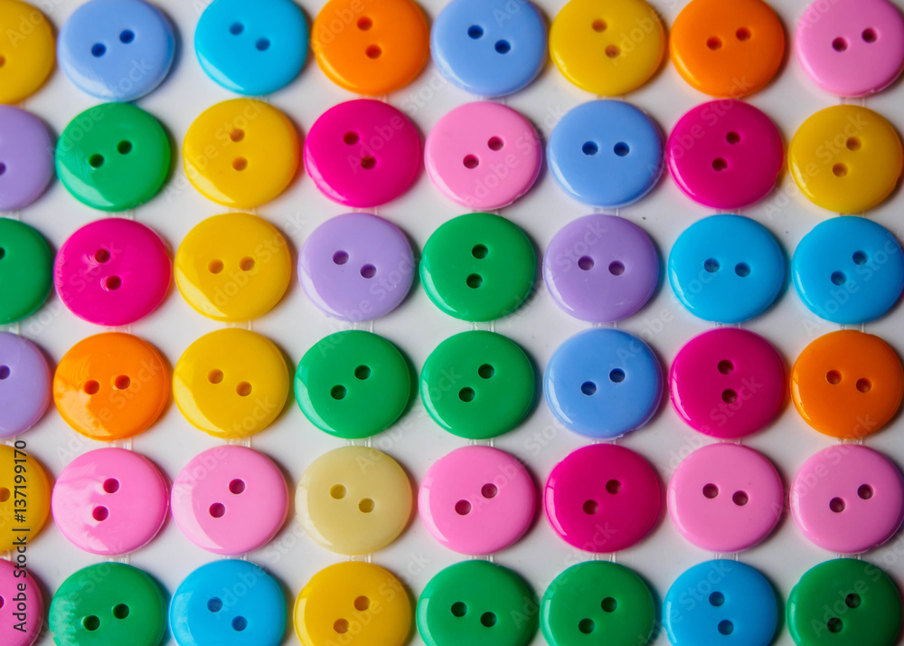 rows of colorful button on white background