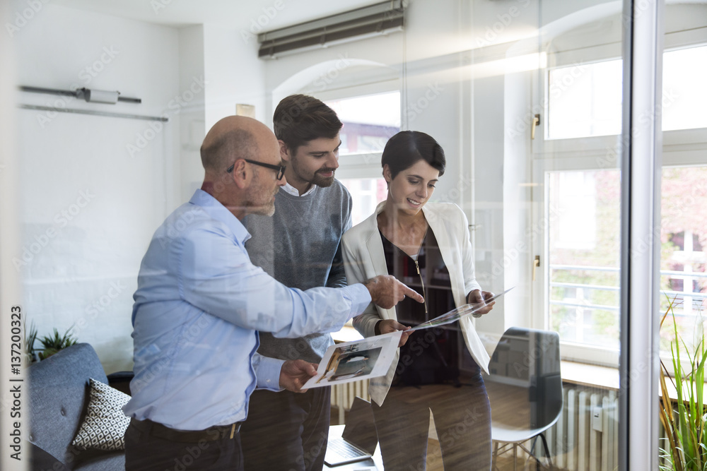Colleagues working together in boardroom