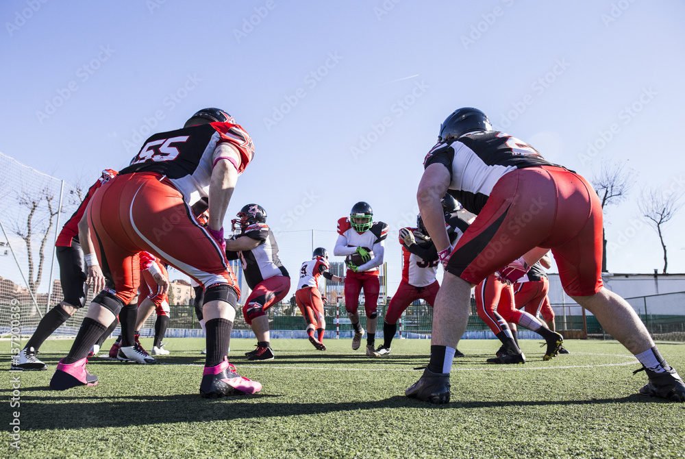American football player running with the ball during a match American football player running with the ball during a match