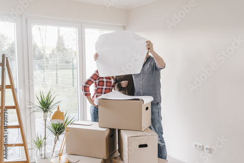 Couple in new home looking at construction plan
