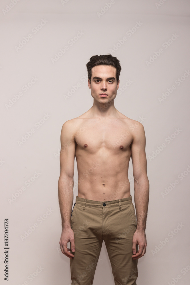 young man model shirtless body posing pants