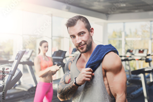 Young athletic man in gym  lifestyle portrait in fitness center