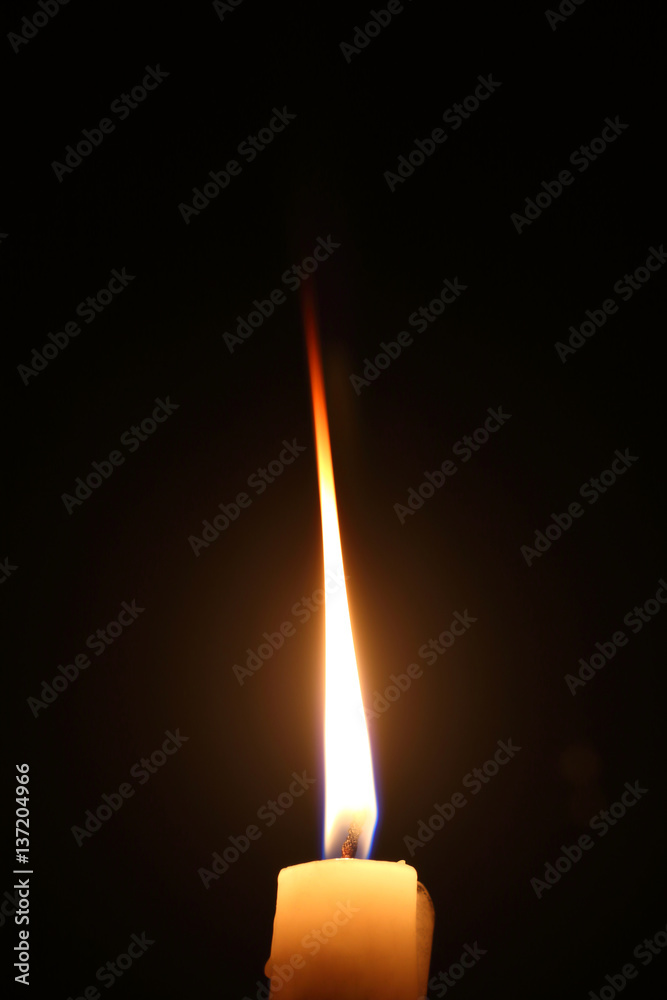 Lighting candles on a black background. Lighting candles on a black background.