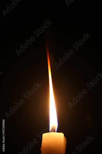 Lighting candles on a black background.