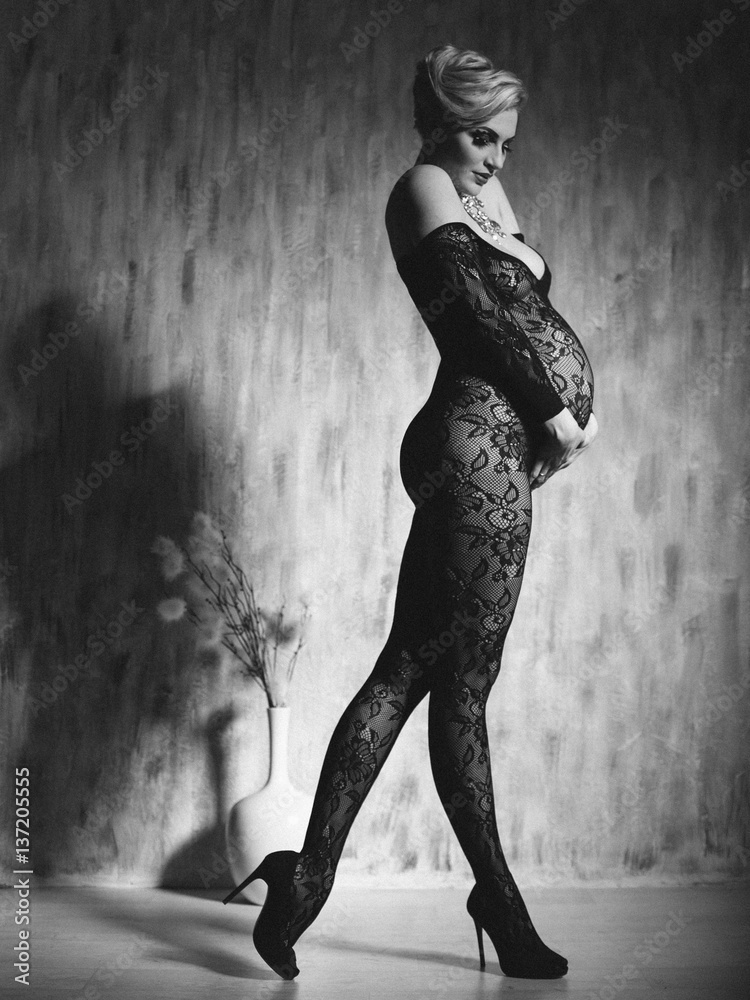 Black and white photo. Pregnant woman in perfect form. Model in the dark. Sexy  pregnancy. Stock Photo | Adobe Stock