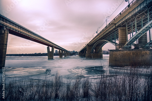 Cold winter day. Two bridges across the ice-covered river Ob. Novosibirsk. Russia.