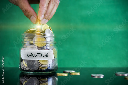 Preparation for future and financial concept. Coins in glass jar with SAVING label. Malaysia coins.