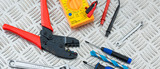 Electrician's Tools and Equipment on Steel Checker Plate
