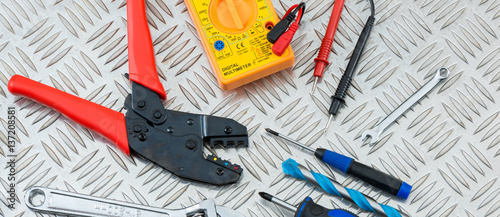 Electrician's Tools and Equipment on Steel Checker Plate