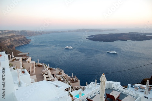 Evening island of Santorini, Greece. Sunset over the Aegean sea. Typical architecture in white and blue tones. Filmed in the journey to the Mediterranean and Cyclades