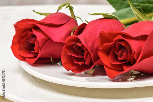 Roses on a white plate. Romantic composition for Valentine's Day, Anniversary...