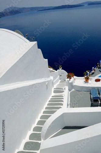 Piece of Mediterranean cruise On Santorini island, Greece. The view from the hotel balcony on the lower terrace and the shore of the Aegean sea. The system of the Cycladic Islands
