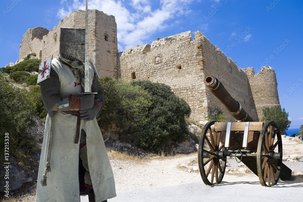 Medieval knight and artillery gun with ruins of a castle in Kritinia built by the Knights of Saint John on the top of rock on the coast of Aegean Sea, Rhodes, Greece