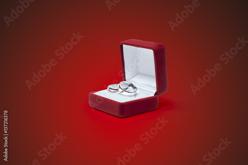 wedding rings and jewelry box on a wooden table © Himchenko
