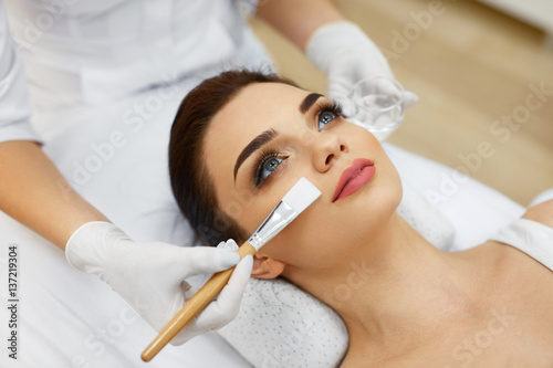 Cosmetician In Spa Salon Hydrating Beautiful Woman's Face